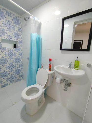 a bathroom with a toilet and a sink at Apartaestudio Marbella #2-10 in Cartagena de Indias