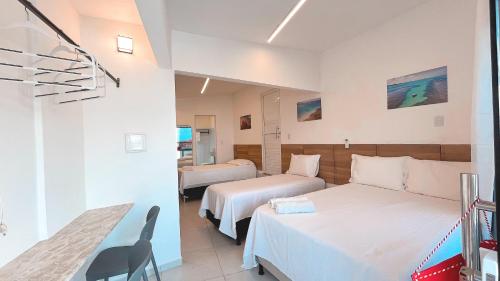 Ένα ή περισσότερα κρεβάτια σε δωμάτιο στο Pousada Beach Claudia