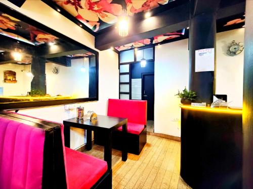 a dining room with a table and red chairs at Jo'stel Hotel Winter Green- MG Marg in Gangtok