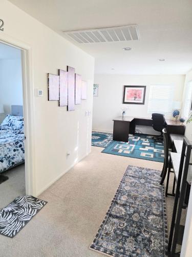 a living room with a bed and a desk at 2-Bedroom Entire Guest Suite in North Las Vegas Mountain Views in Las Vegas