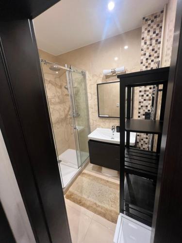 a bathroom with a shower and a sink at Šafran Apartment LUX in Donovaly