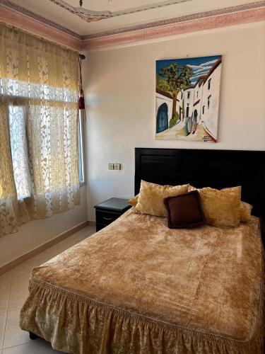 Una cama o camas en una habitación de ksar sghir,Tanger Med