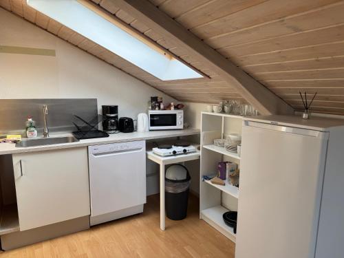 a kitchen with a sink and a microwave at Cozy Apartment in Billund in Billund