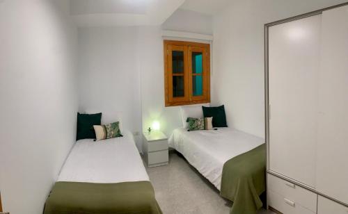 En eller flere senge i et værelse på Fuerteventura Urlaub