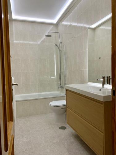 a bathroom with a toilet and a sink and a shower at Fuerteventura Urlaub in Puerto del Rosario