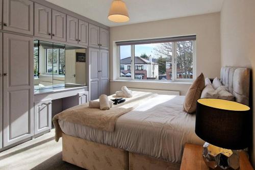 a bedroom with a large bed and a large window at 2 minute walk to LUAS (tram) in Dublin