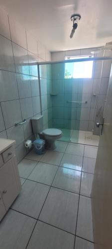 a bathroom with a toilet and a glass shower at Edifício Vitória 1 Apt 203 in Marcelino Ramos
