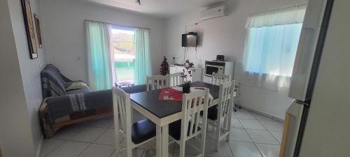 a dining room with a table and chairs in a room at Edifício Vitória 1 Apt 203 in Marcelino Ramos