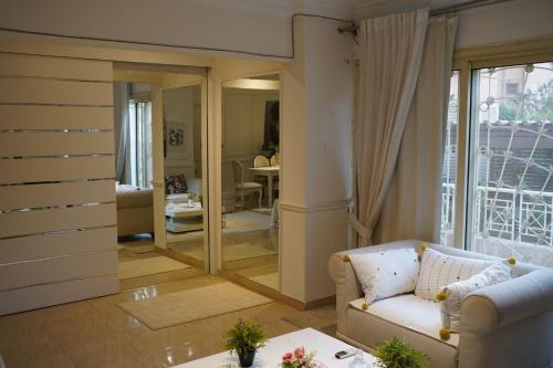 a living room with a white couch and a living room at Garden Home in Sheikh Zayed