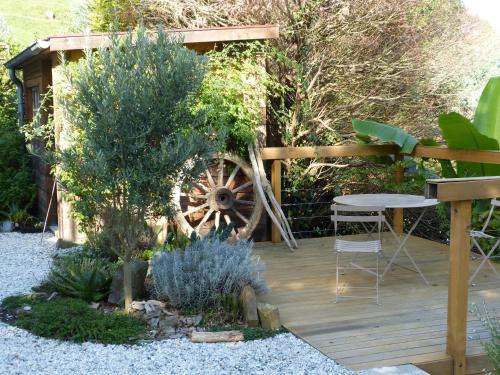 a garden with a wooden deck with a wheel at Dorre Pean in Ciboure