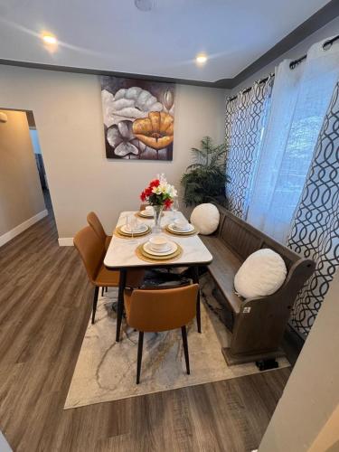 a dining room with a table and a couch at Luxe Living Prime Location in Kitchener