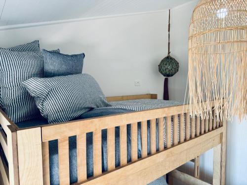 a swing bed in a room with pillows at Barbara's Beach House in Hallidays Point