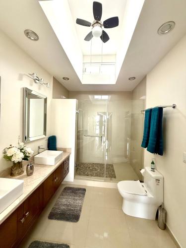a bathroom with a toilet and a ceiling fan at Grand Retreat in La Paz
