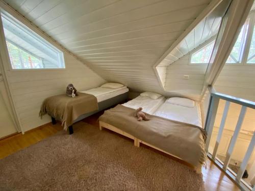 a room with two beds in a attic at Villa Adalia in Kalajoki