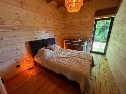 a bedroom with a bed in a log cabin at Domek nad jeziorem w górach in Międzybrodzie Bialskie