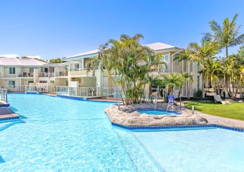 a swimming pool at a resort with a resort at 2 Bedroom Pacific Blue Poolside Escape - Oaks Port Stephens Pacific Blue Resort in Salamander Bay