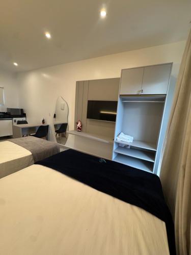 a hotel room with two beds and a desk at Vila Eco Barra AP 209 in Barra Grande