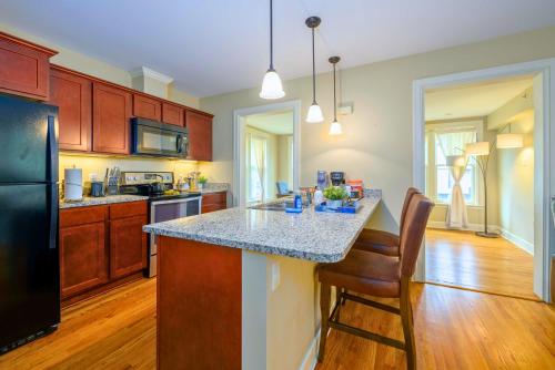 a kitchen with a island with a counter top at Westcott Suite Apartments in Syracuse