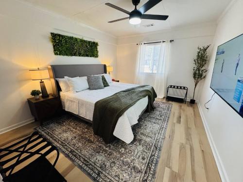 a bedroom with a bed and a ceiling fan at Redbud Waterfront (Augusta Canal), king bed in Augusta