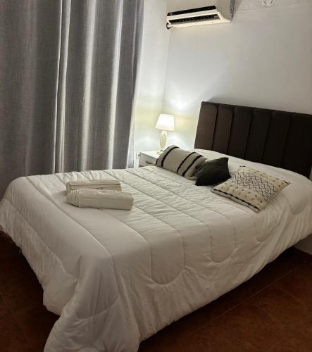 a bedroom with a large bed with white sheets and pillows at Yaya Home - Recoleta in Asunción