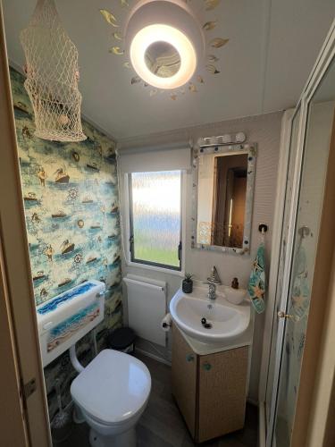 a small bathroom with a sink and a toilet at Sunset Seeker Morecambe in Morecambe