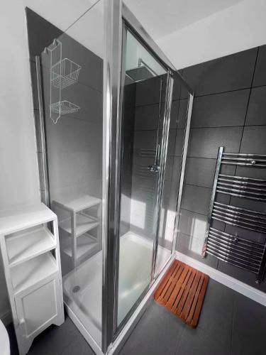 a bathroom with a shower with a wooden mat at Stylish One Bed Apartment in Edinburgh