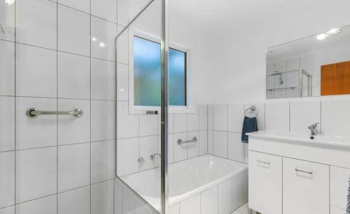 a bathroom with a shower and a tub and a sink at Blue Lagoon in American River