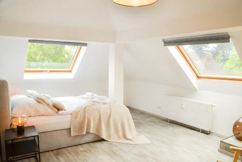 a white bedroom with a bed and two windows at MILPAU Bottrop1 - Zentrales, modernes Design-Apartment - Smart TV, Nespresso, für 4 Personen in Bottrop