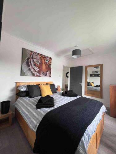 a bedroom with a large bed with black and yellow pillows at Stylish One Bed Apartment in Edinburgh
