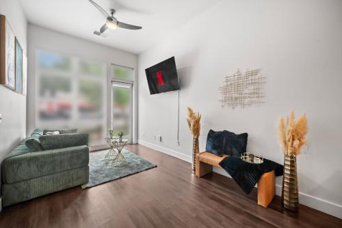 a living room with a couch and a tv at Haven Verde in Atlanta