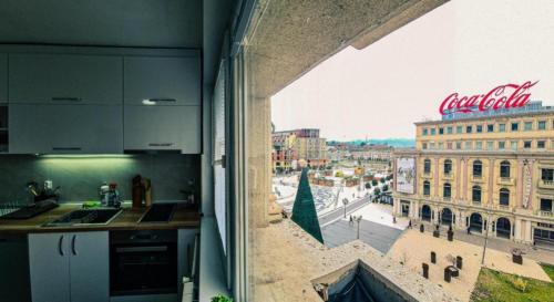 a kitchen with a view of a city from a window at Mother Teresa Apartments FREE PARKING in Skopje