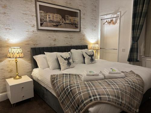 a bedroom with a bed with two towels on it at Brig O'Doon Guest House in Edinburgh