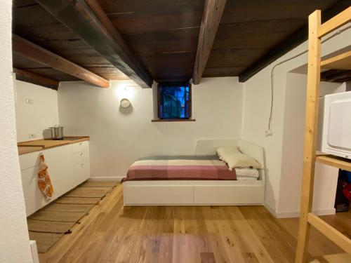 a small bedroom with a bed and a window at La Casetta in Bannio