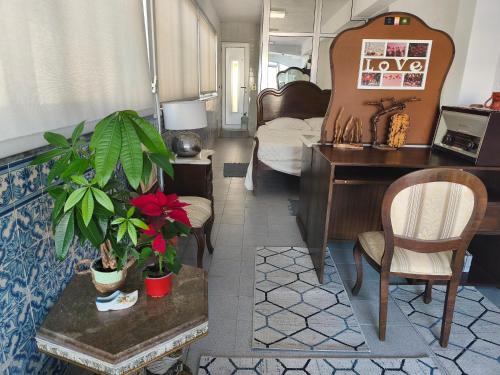 a living room with a desk and a bedroom at Orion Casais in Casais