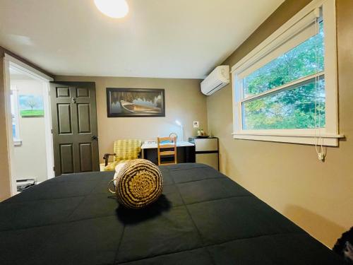 a bedroom with a large bed and a window at Comfort Room-Free Parking & Cozy Stay in Charlottetown in Charlottetown
