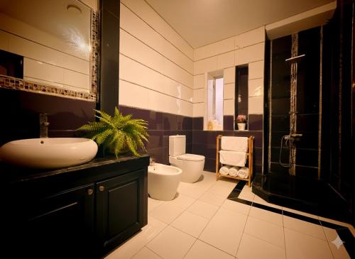 a bathroom with a sink and a toilet at Luxury Villa with pool 6 min to Football Stadium CAF in Rabat