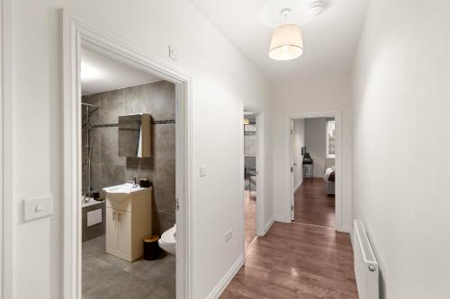 a white bathroom with a toilet and a sink at 1Bed Gem Central Bletchley Perfect for Contractors in Bletchley