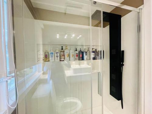 a bathroom with a glass shower stall with a sink at Cozy Small Room - Queen bed - Free Parking in Charlottetown in Charlottetown