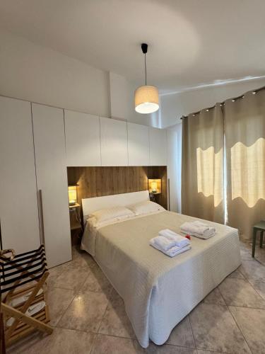 a bedroom with a large bed with towels on it at Bella Todi Apartment in Todi