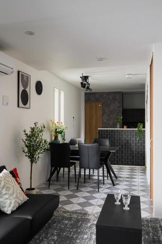 a living room with a couch and a dining room at Skytree View Riverside Terrace in Tokyo
