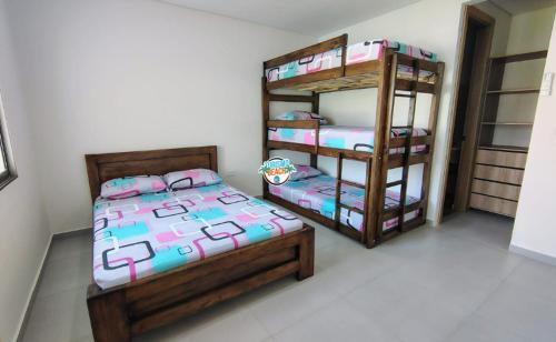 a bedroom with two bunk beds and a ladder at Sun Beach in Puerto Colombia