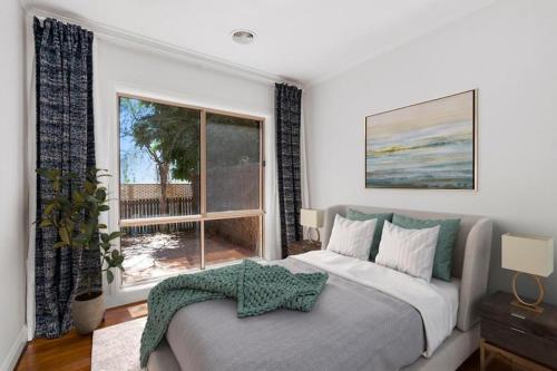 a bedroom with a bed and a large window at Inner North Premier Turner Living 2 Bed, 2 Bath Townhome in Turner