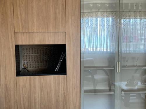 a wooden cabinet with a fireplace in a room at Apê da Paula in Torres