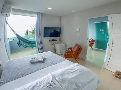 Un dormitorio con una cama y vista al mar. en Casa Bela Vista, en Japaratinga