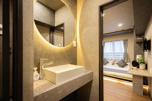 a bathroom with a sink and a mirror at New mansion 7 mins from Yoyogi stations in Tokyo