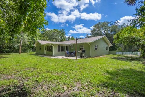 a green house with a yard at Crystal River Getaway in Crystal River