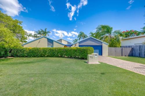 a yard with houses and a fence and grass at 22 Bussey Street in Bargara