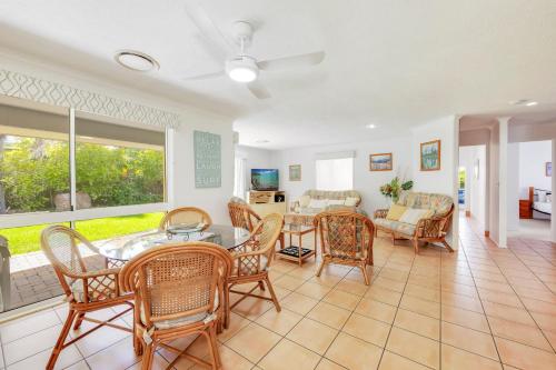 a living room with a table and chairs at 22 Bussey Street in Bargara