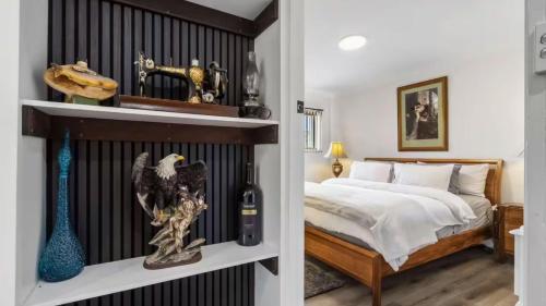 a bedroom with a bed and a bottle of wine at Vineyard Accommodation in Dorrien