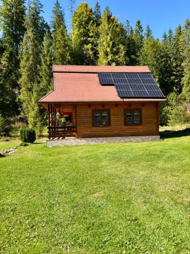 a log cabin with solar panels on the roof at Chata MOBY in Važec